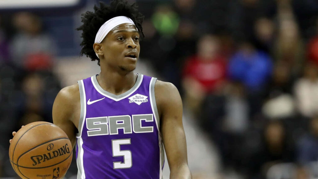 De'Aaron Fox Sacramento Kings intense expression handling basketball vibrant NBA wallpaper