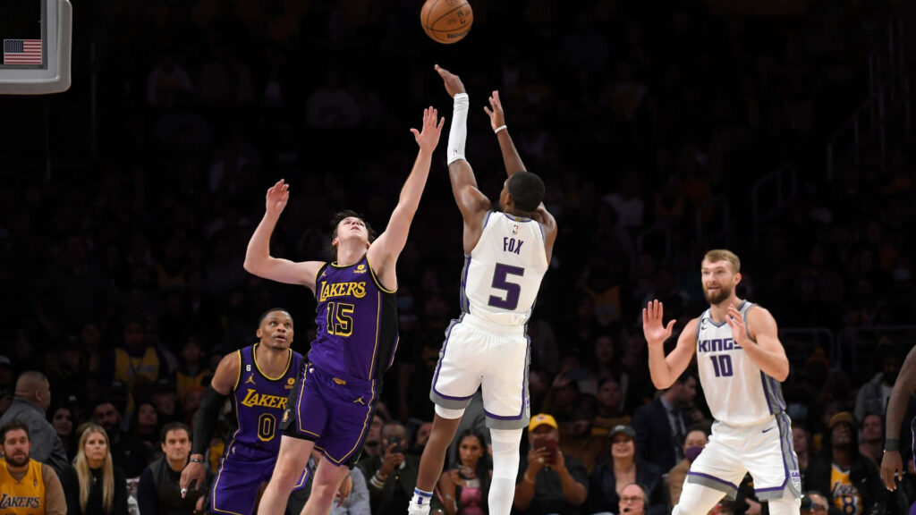 De'Aaron Fox Sacramento Kings shoots three over Austin Reaves Lakers intense late-game action Wallpaper