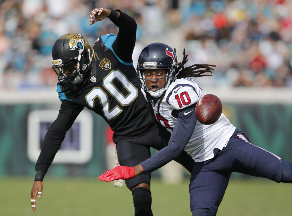 DeAndre Hopkins NFL action evading Jaguars defender vibrant football wallpaper background