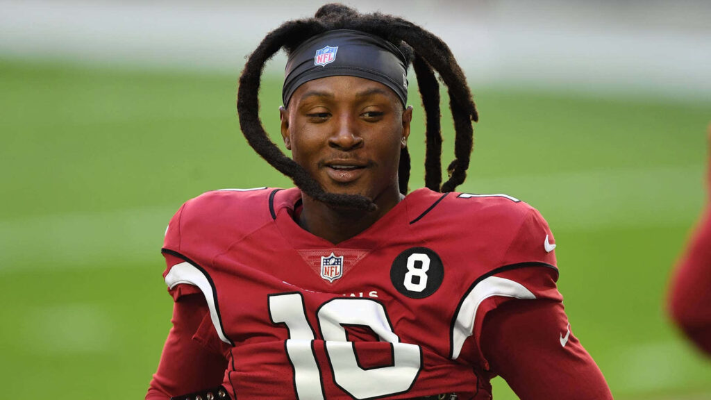 DeAndre Hopkins in red number 10 jersey with confident look blurred stadium NFL wallpaper background