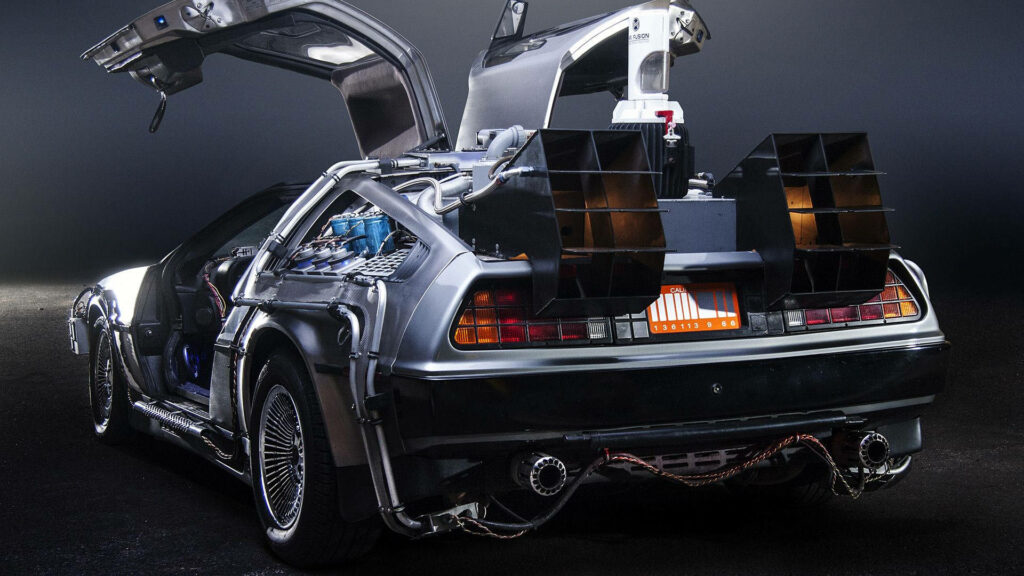 DeLorean Time Machine with open gull-wing doors glowing futuristic lights wallpaper background