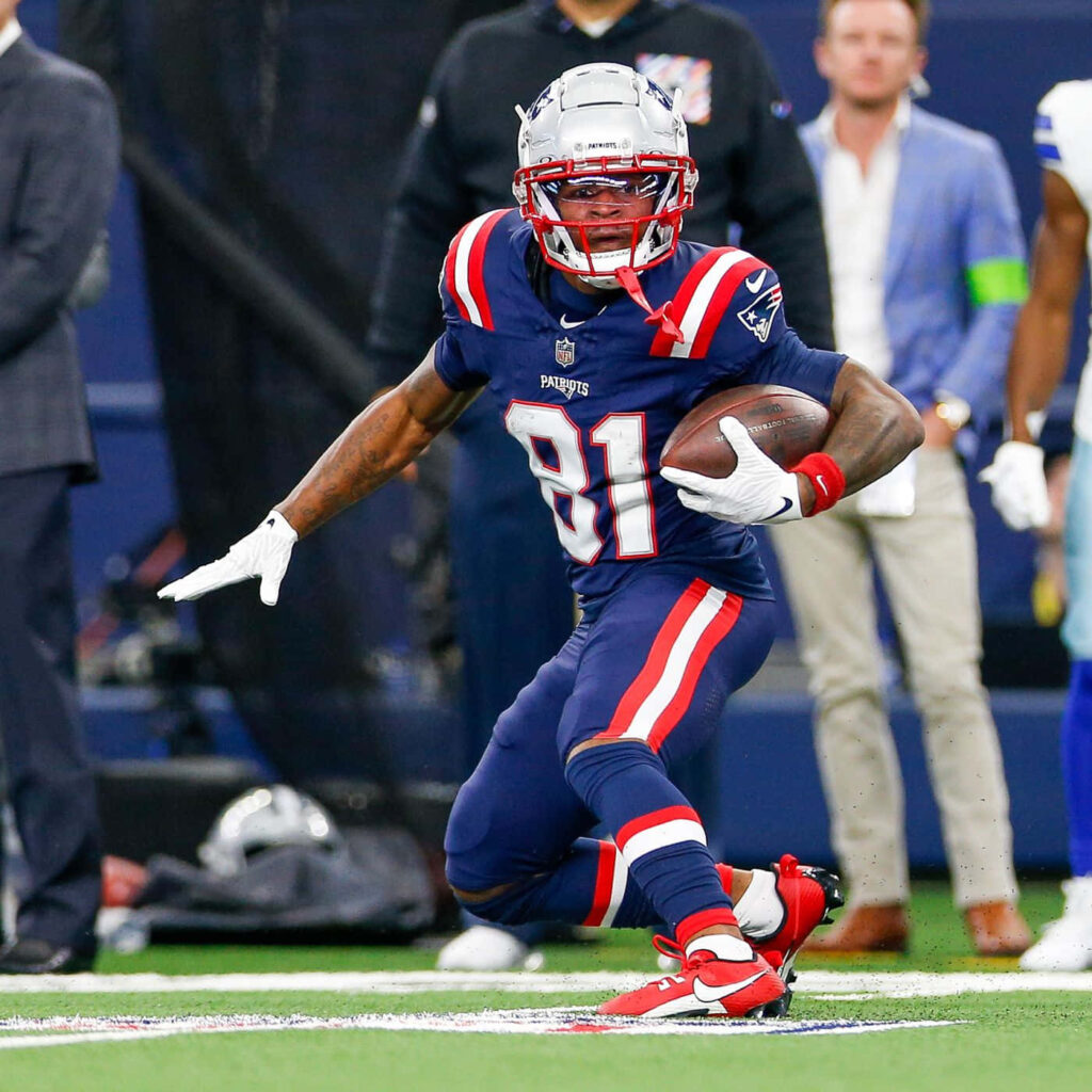 DeMario Douglas number 81 New England Patriots dynamic football run vibrant stadium background Wallpaper