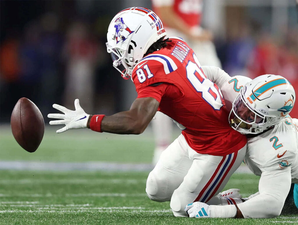 DeMario Douglas lunges in Patriots uniform recovering fumble tackled by Miami Dolphins defender Wallpaper