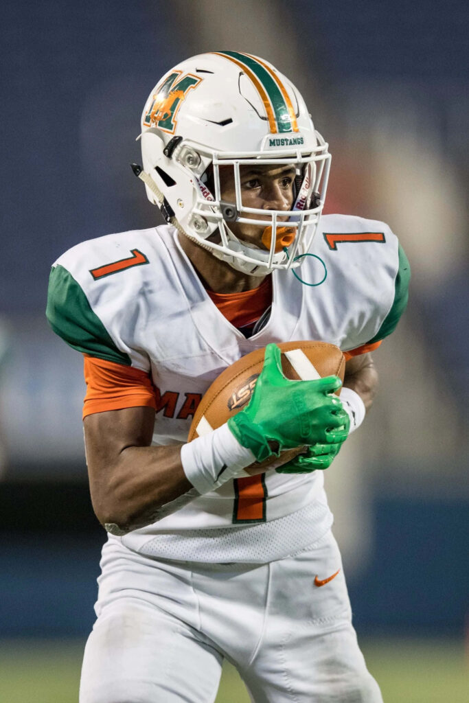 DeMario Douglas focused catching football in white green Mustangs uniform vivid sports action Wallpaper