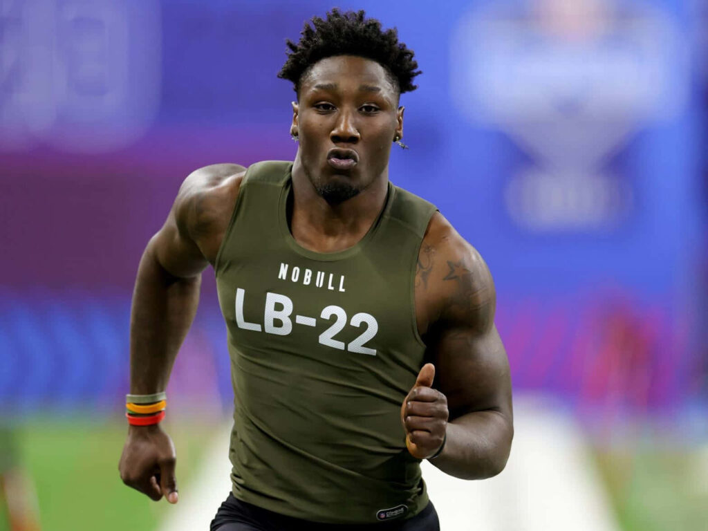 DeMarvion Overshown sprinting intensely showcasing athletic power football wallpaper background