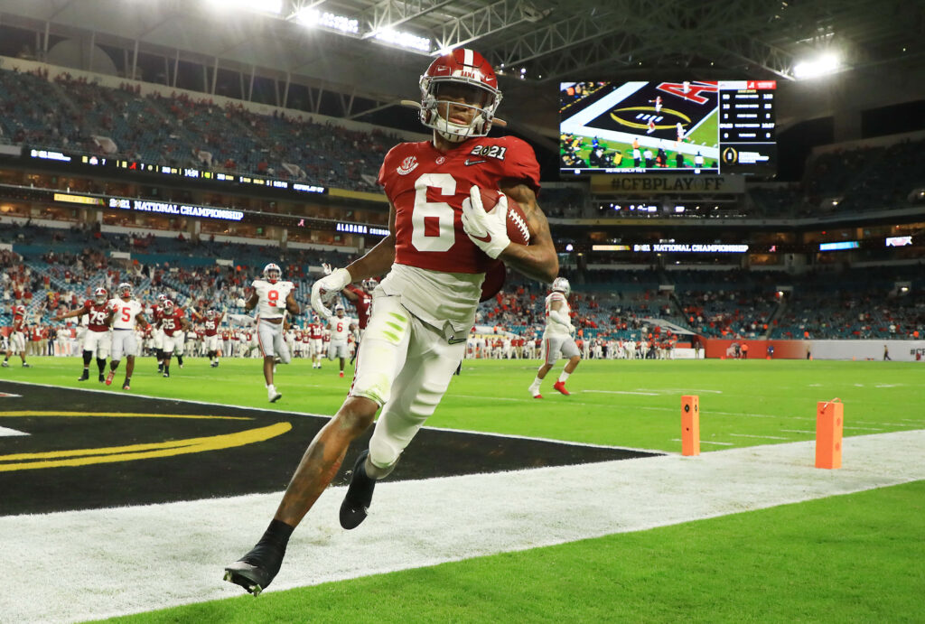 DeVonta Smith Alabama touchdown celebration vibrant stadium lights championship wallpaper