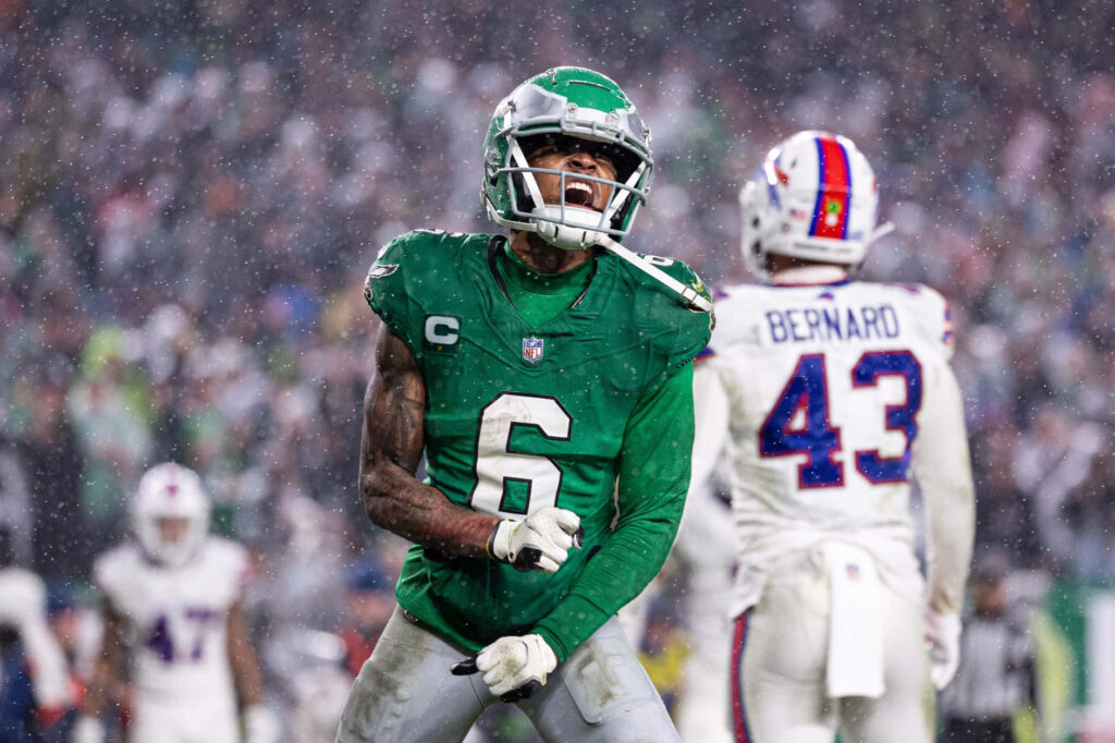 DeVonta Smith Eagles celebrate intense rainy NFL game with Buffalo Bills Christian Bernard background Wallpaper