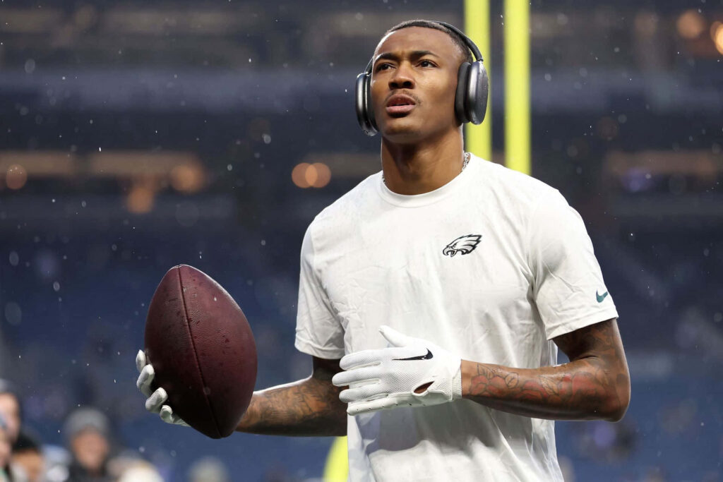 DeVonta Smith focused preparing to catch football in white shirt and gloves during warm-up Wallpaper