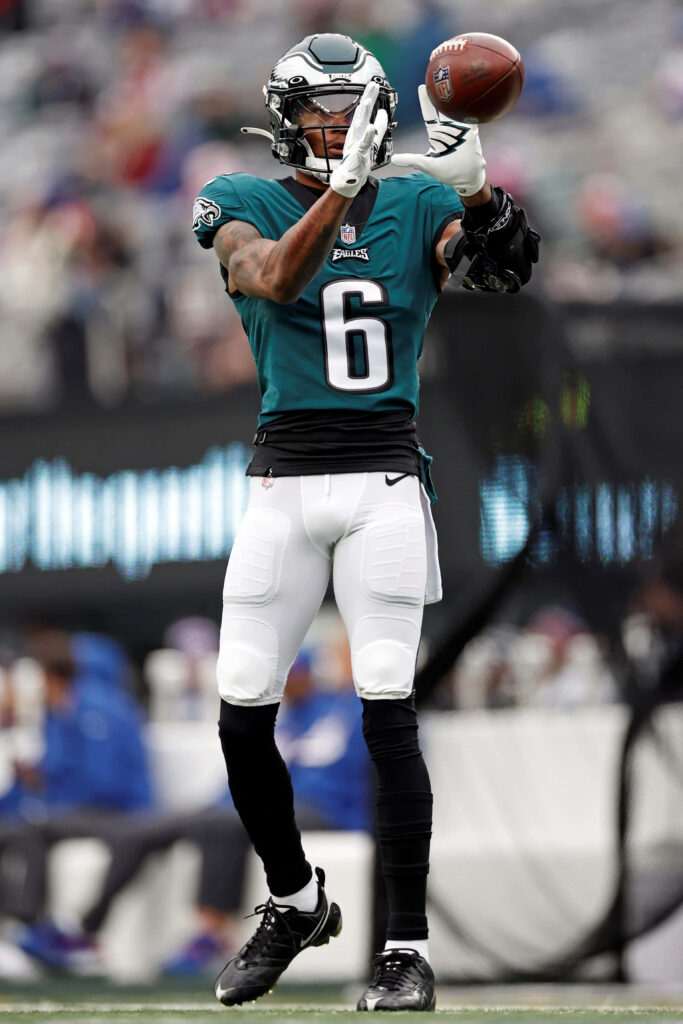 DeVonta Smith catching football in Philadelphia Eagles green white uniform action photo Wallpaper