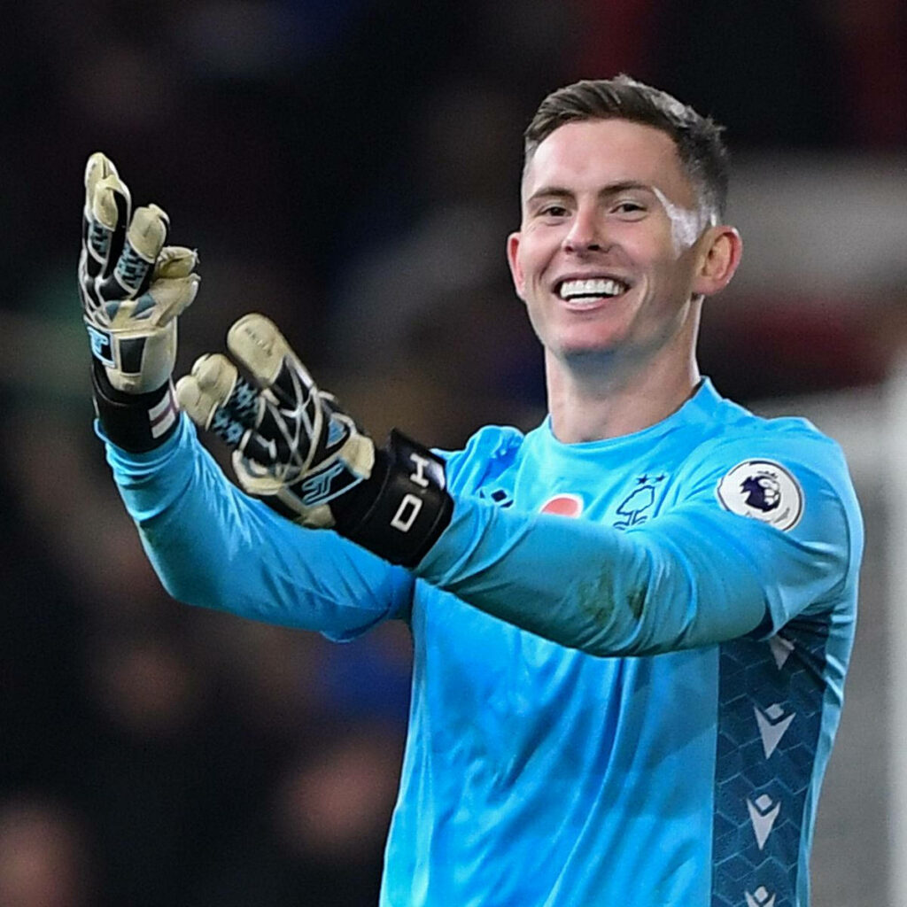 Dean Henderson in bright blue goalkeeper kit poised for a crucial save dynamic soccer wallpaper
