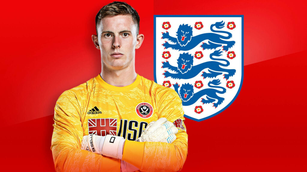 Dean Henderson in bright yellow England goalkeeper kit against red background showing national crest Wallpaper