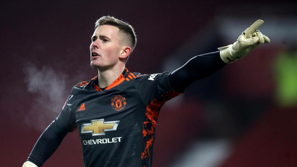 Dean Henderson Manchester United goalkeeper passionately directing teammates wearing black orange kit Wallpaper