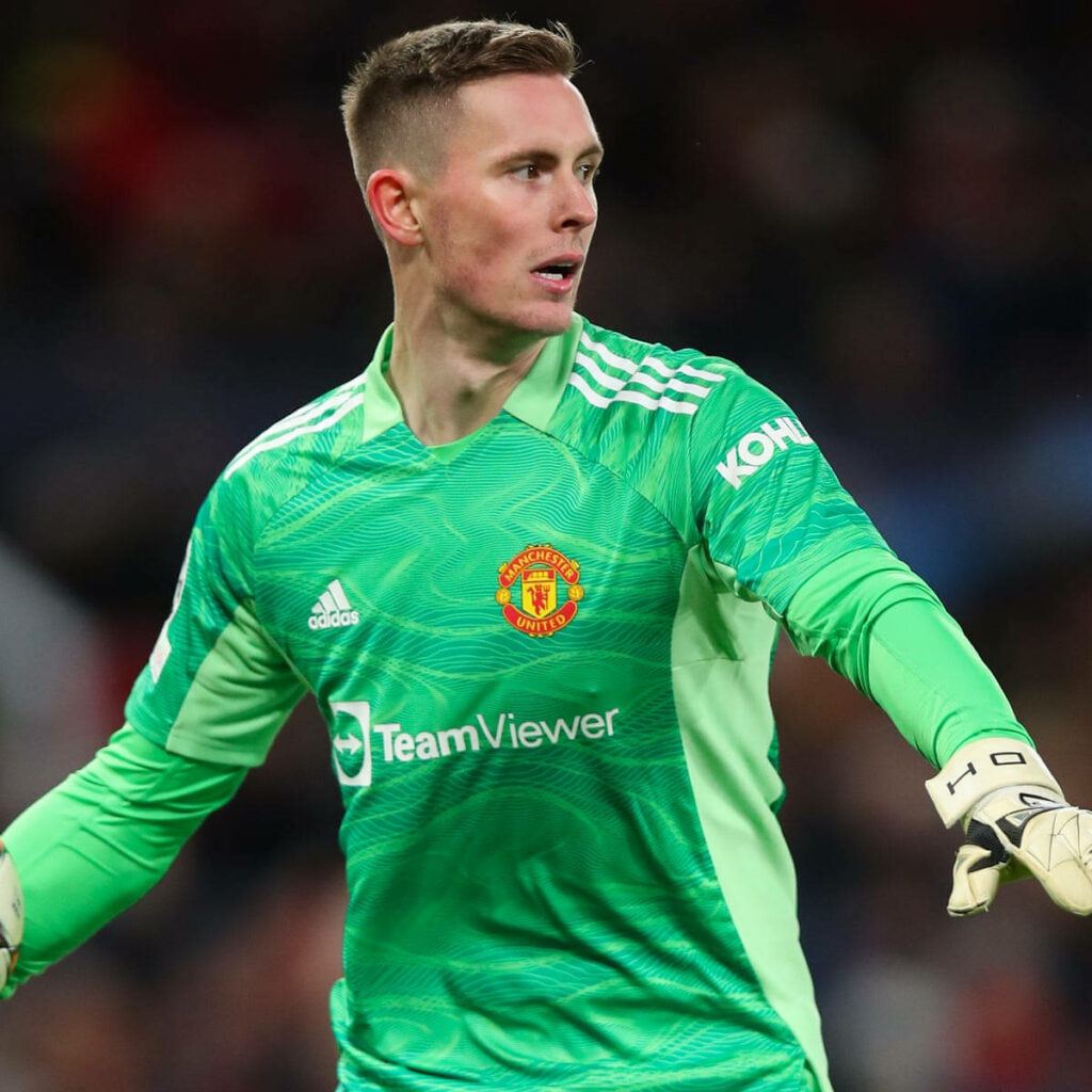 Dean Henderson in bright green Manchester United goalkeeper kit ready in vibrant stadium wallpaper