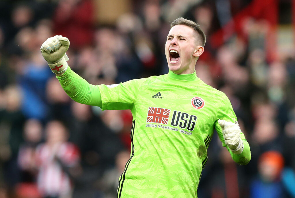 Dean Henderson Sheffield United goalkeeper celebrating with fist pump in neon green kit stadium background Wallpaper