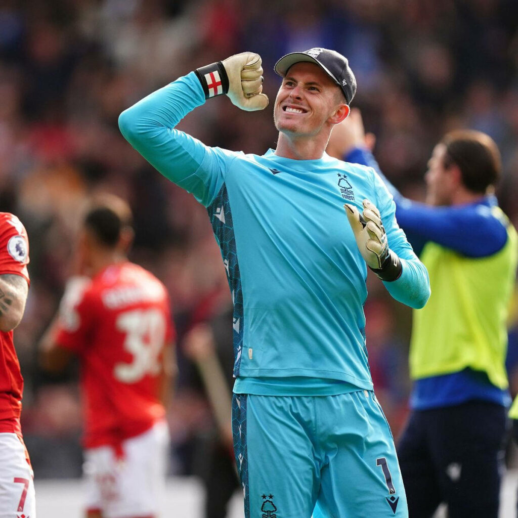 Dean Henderson celebrates in bright blue Nottingham Forest goalkeeper kit during Premier League match Wallpaper