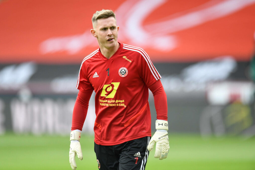 Dean Henderson in red Sheffield United goalkeeper jersey frowning intense football stadium wallpaper