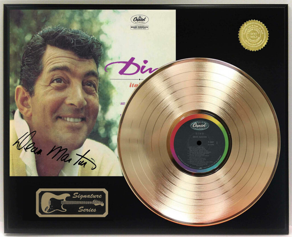 Dean Martin smiling next to gold record with vintage Capitol Records cover and autograph background Wallpaper