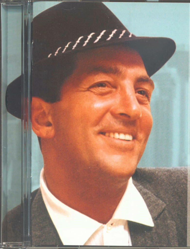 Dean Martin vintage portrait with fedora and suit on soft blue background The Very Best Of Wallpaper