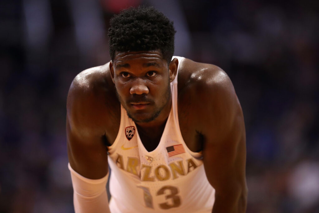 Deandre Ayton in white Arizona Wildcats jersey focused during intense men's college basketball game Wallpaper