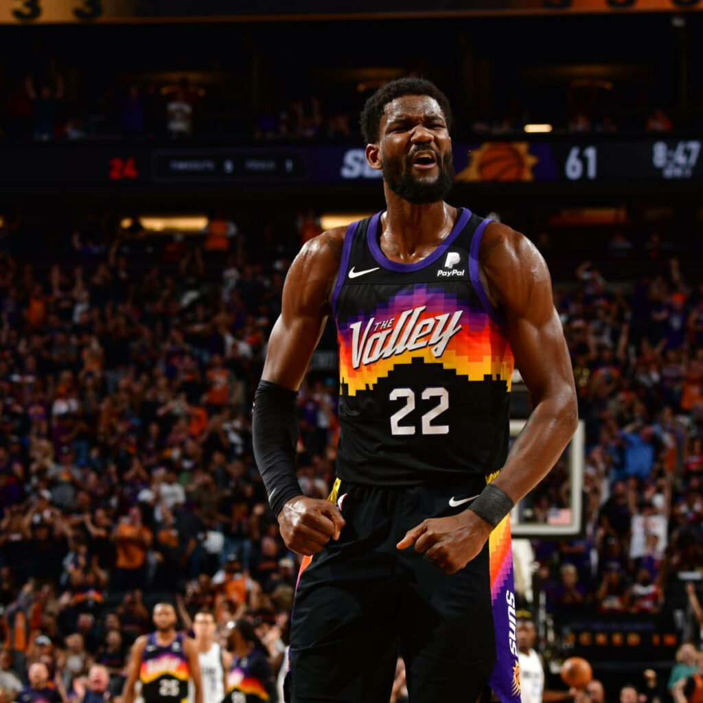 Deandre Ayton at center court in Phoenix Suns uniform during intense NBA game versus Mavericks Wallpaper