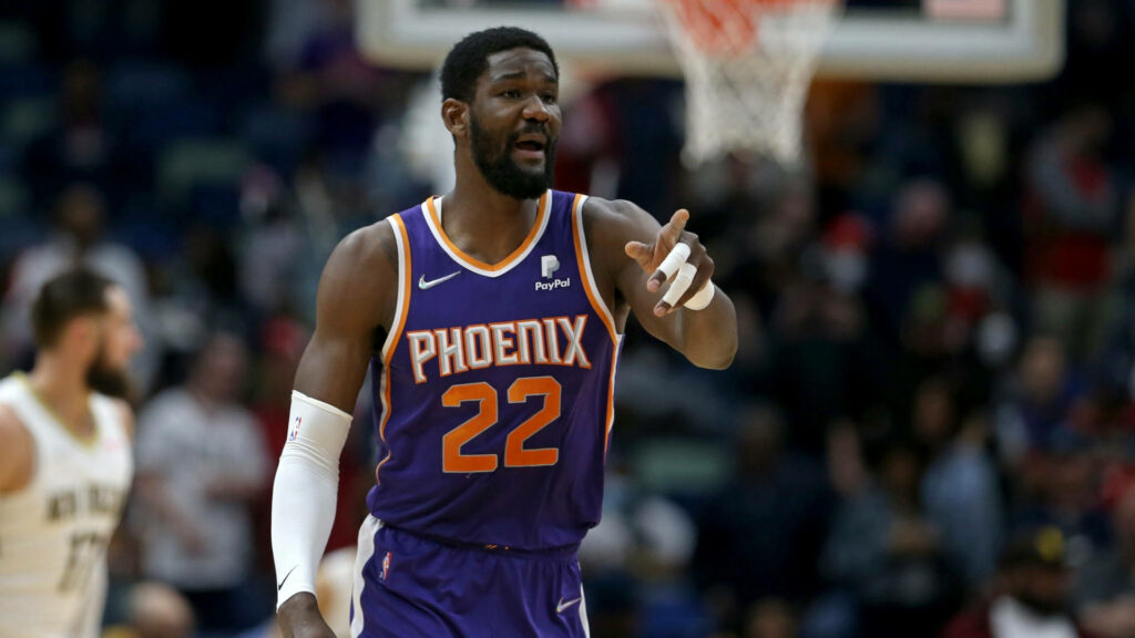 Deandre Ayton Phoenix Suns No 22 in purple orange jersey playing basketball on lively court Wallpaper