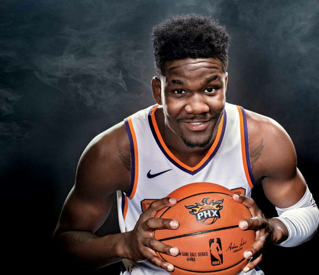 Deandre Ayton Phoenix Suns powerful basketball pose dark smoky background dynamic wallpaper