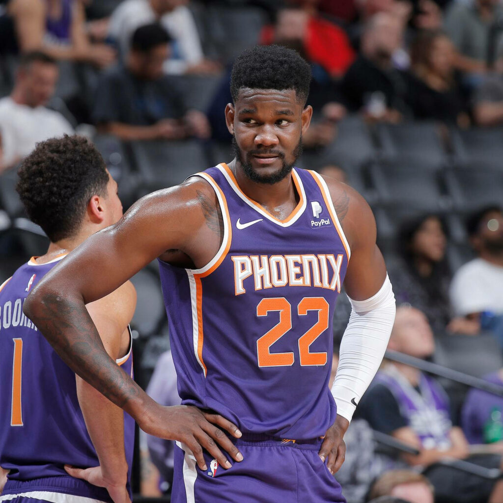 Deandre Ayton in Phoenix Suns purple and orange uniform focused during intense NBA game wallpaper
