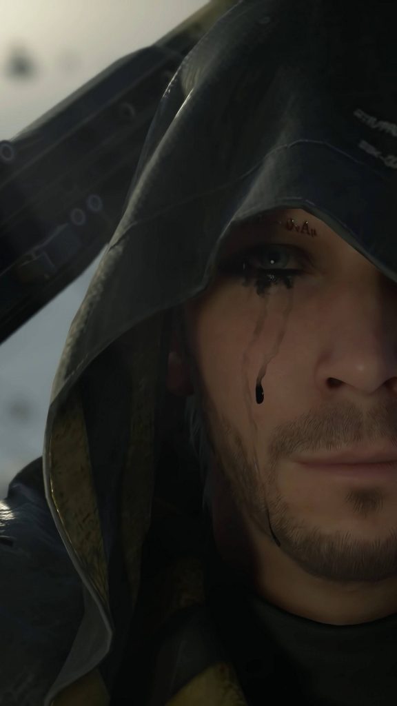 Extreme close-up of Higgs Death Stranding iPhone wallpaper dark hood piercing eyes black tear
