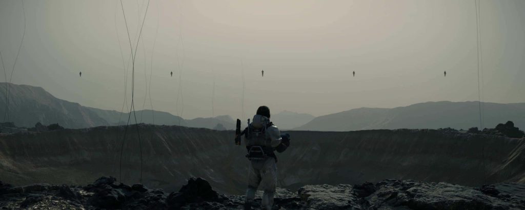 Death Stranding PC wallpaper Sam Porter Bridges overlooks misty crater with floating shadowy figures