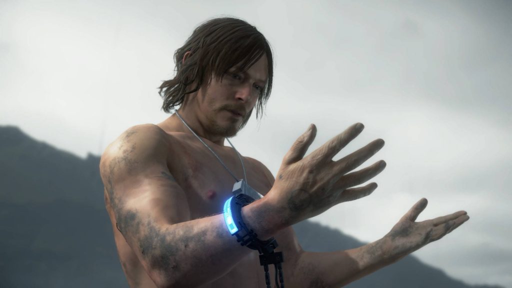 Sam Porter Bridges shirtless with glowing blue cuff in Death Stranding cinematic mountain wallpaper