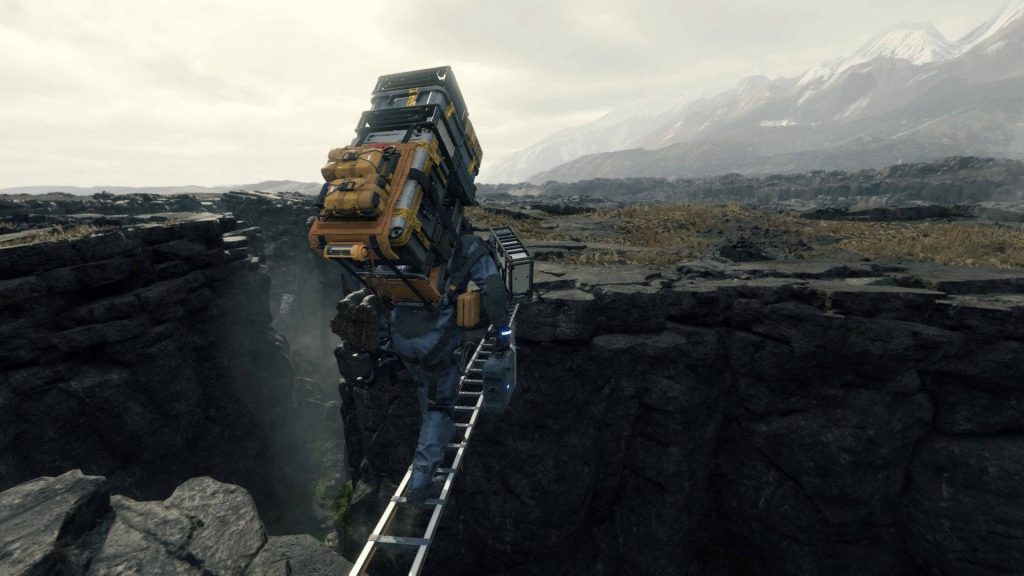 Sam Porter Bridges crossing rocky chasm with ladder hauling cargo Death Stranding wallpaper