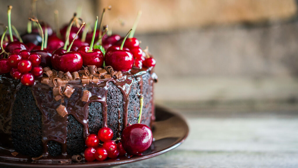 Black Forest Cake with Luscious Cherry Accents and Rich Chocolate Sauce. Wallpaper