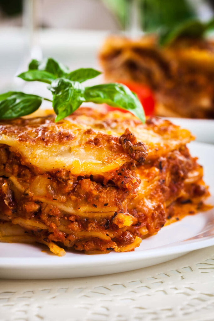 Delicious Lasagna Alla Bolognese Close-Up: Pasta, Meat Sauce & Basil Wallpaper