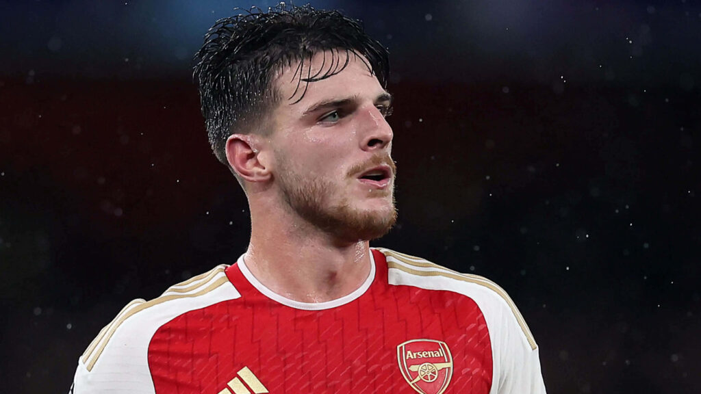 Declan Rice in red Arsenal jersey playing soccer with focused expression high definition wallpaper