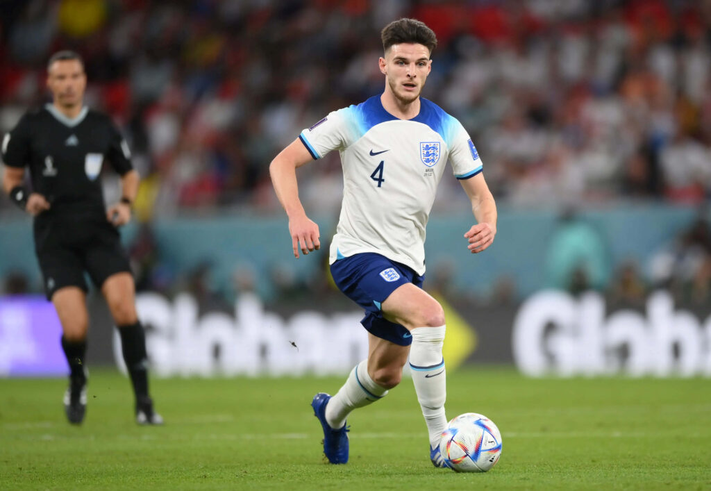 Declan Rice in England football kit showing focus and athleticism during intense match action Wallpaper