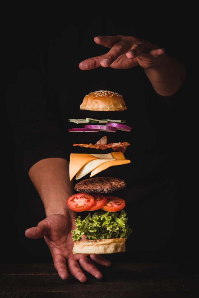 Deconstructed Burger Wallpaper: Vibrant Ingredients on Dark Background