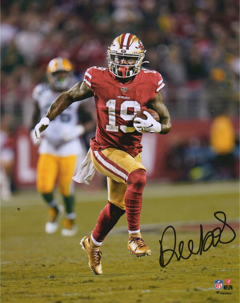 Deebo Samuel Sr in red gold 49ers uniform running with football dynamic sports wallpaper
