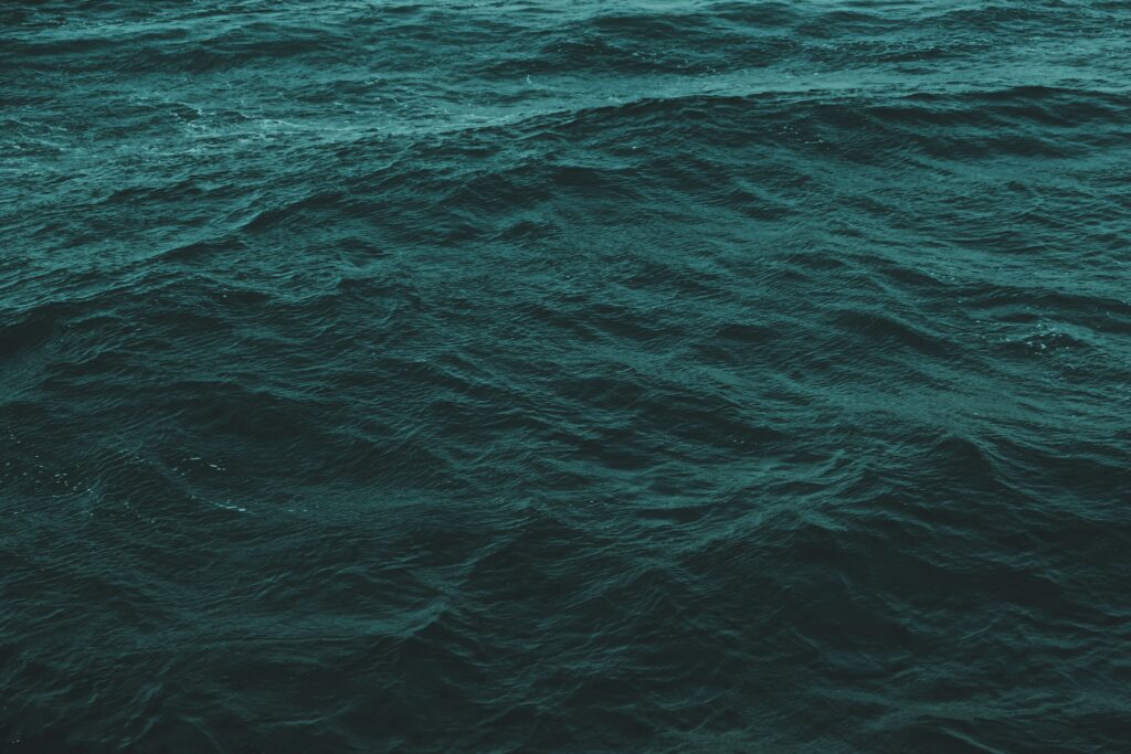Ocean wallpaper showing deep blue green rippling waves creating a tranquil dynamic sea texture