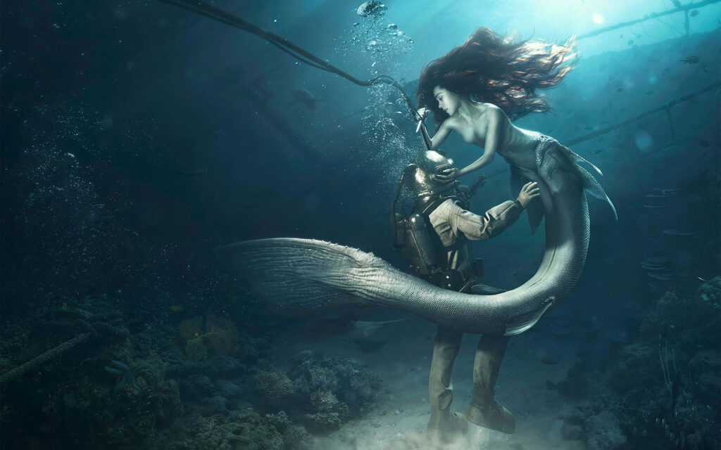 Diving into Fantasy: A Captivating Underwater Encounter with a Real Mermaid and Diver Wallpaper