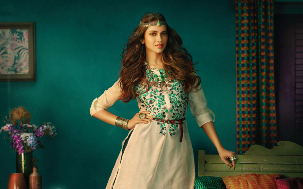 Deepika Padukone in embroidered kurta with statement jewelry against rich teal modern ethnic decor Wallpaper