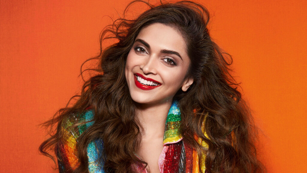 Deepika Padukone Vogue 2018 cover radiant makeup wavy hair sparkling jacket vibrant orange background Wallpaper