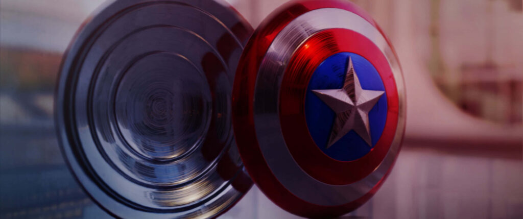 Epic Heroism: Captain America Brandishing Iconic Shield amidst Vibrant Resonance Wallpaper