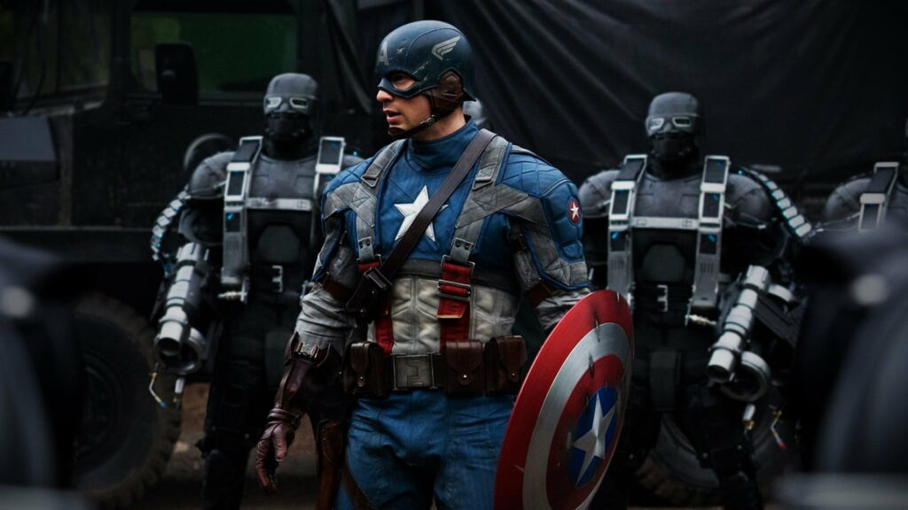 Captain America in iconic suit with shield, leading tactical team in intense action scene | Avengers wallpaper