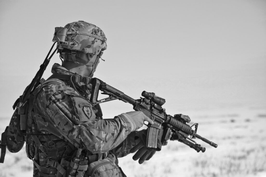 Defending Freedom: The Focused Soldier in Monochrome Wallpaper