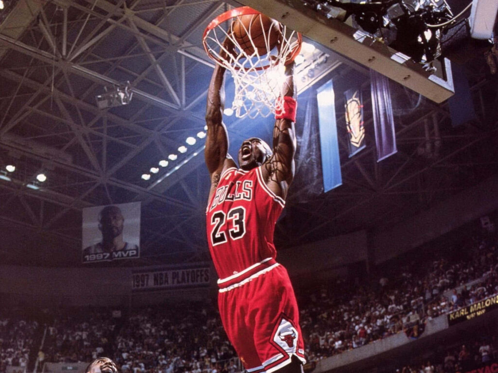 The Airborne Icon: Michael Jordan Showcasing Supreme Dunk Skills Wallpaper