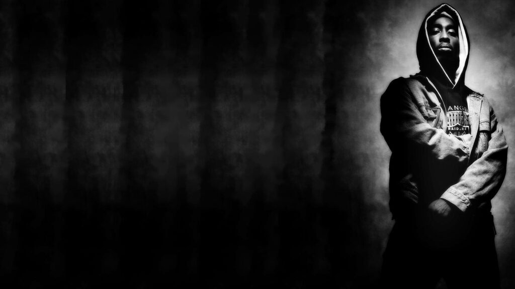 Defiant Eyes of Tupac Shakur: Challenging Conventions and Inspiring Resilience Wallpaper