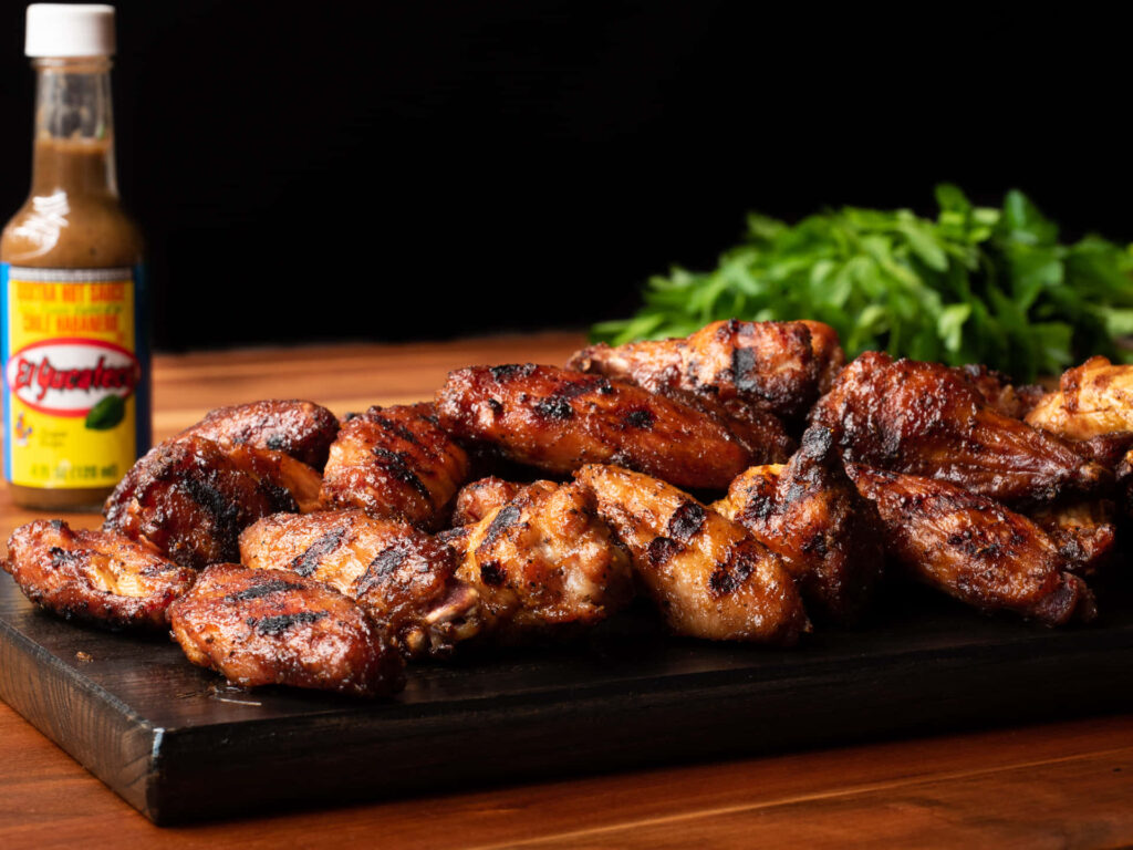 Delectable BBQ Chicken Wings Wallpaper with Rustic Platter & Greens