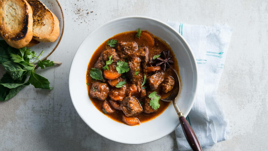 Beef Bourguignon Wallpaper: Hearty Dish with Bread - Delicious Background