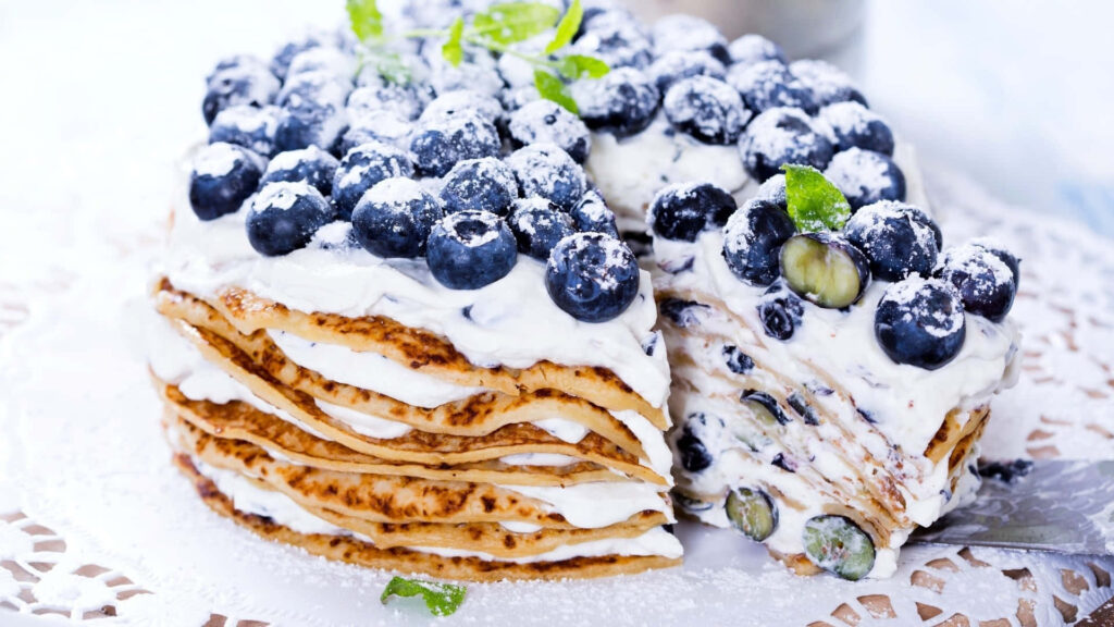 Satisfyingly Sweet Pancake Delight: Blueberry, Cream, and Powdery Bliss! Wallpaper