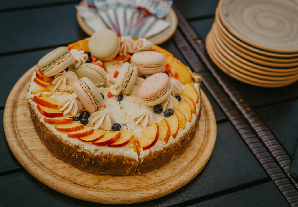 Colorful Cake with Macarons & Fruit on Wooden Plate - Wallpaper